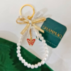 Luna Charm – Pearl Keychain with Gold Bow & Butterfly Pendant | CHAMMAQ - Image 2
